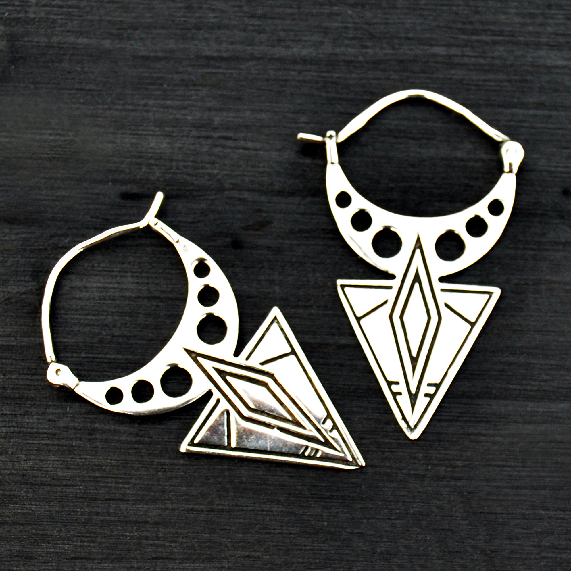 Aztec silver tribal earrings on black background