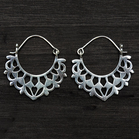 Tribal silver balinese earrings on black background