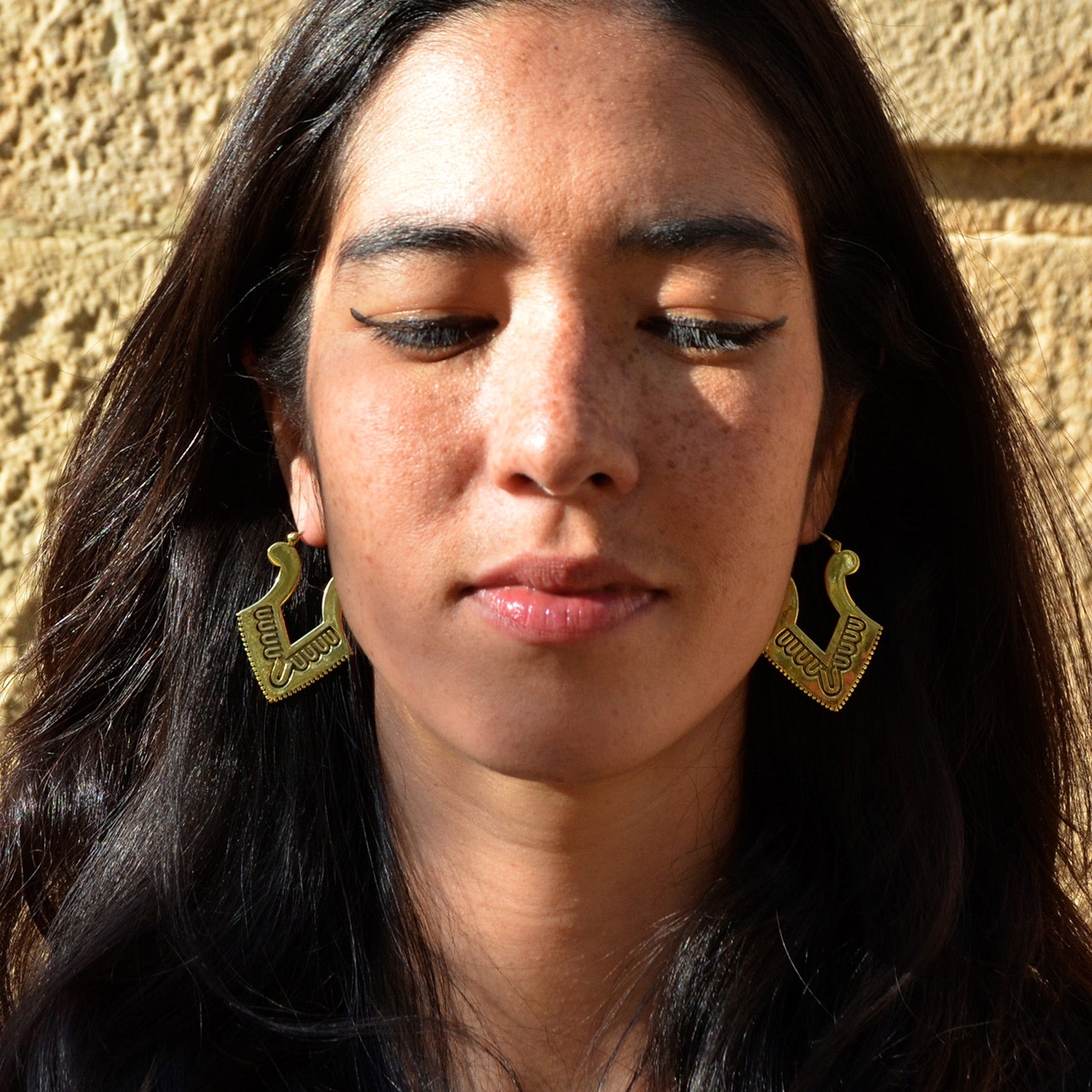 Young woman with aztec gold earrings