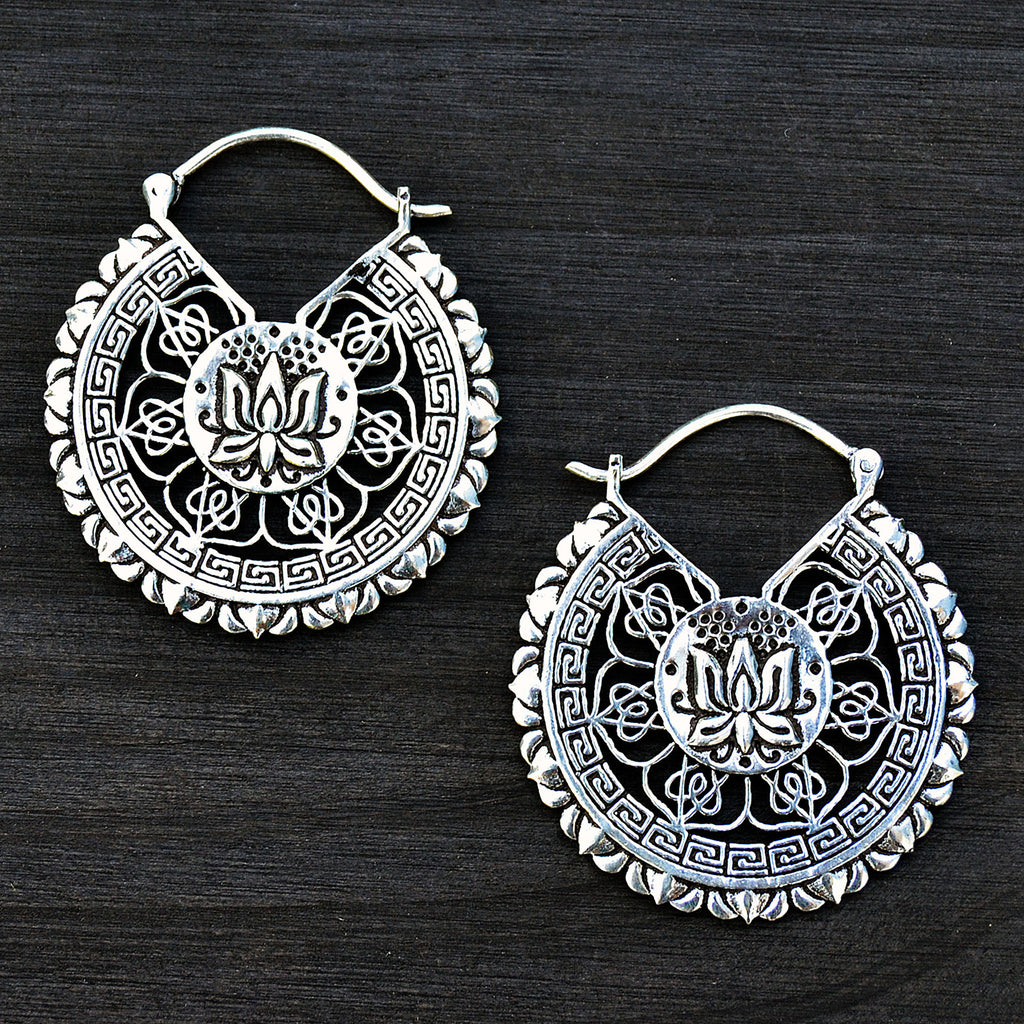 Lotus silver mandala earrings on black background