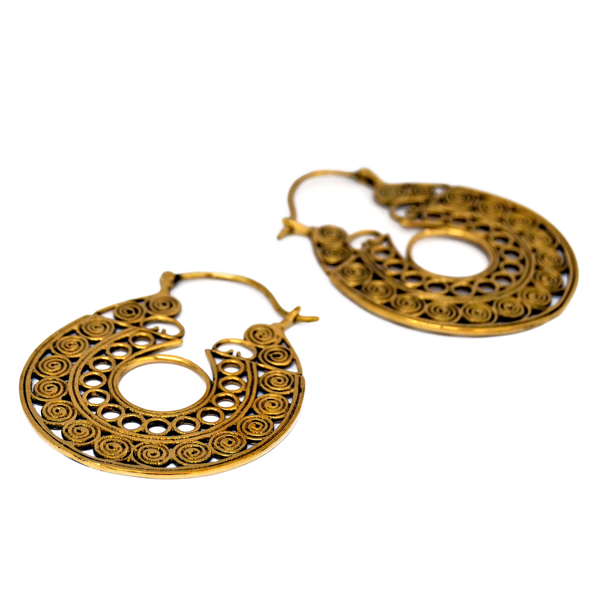 Golden tribal filigree hoop earrings on white background