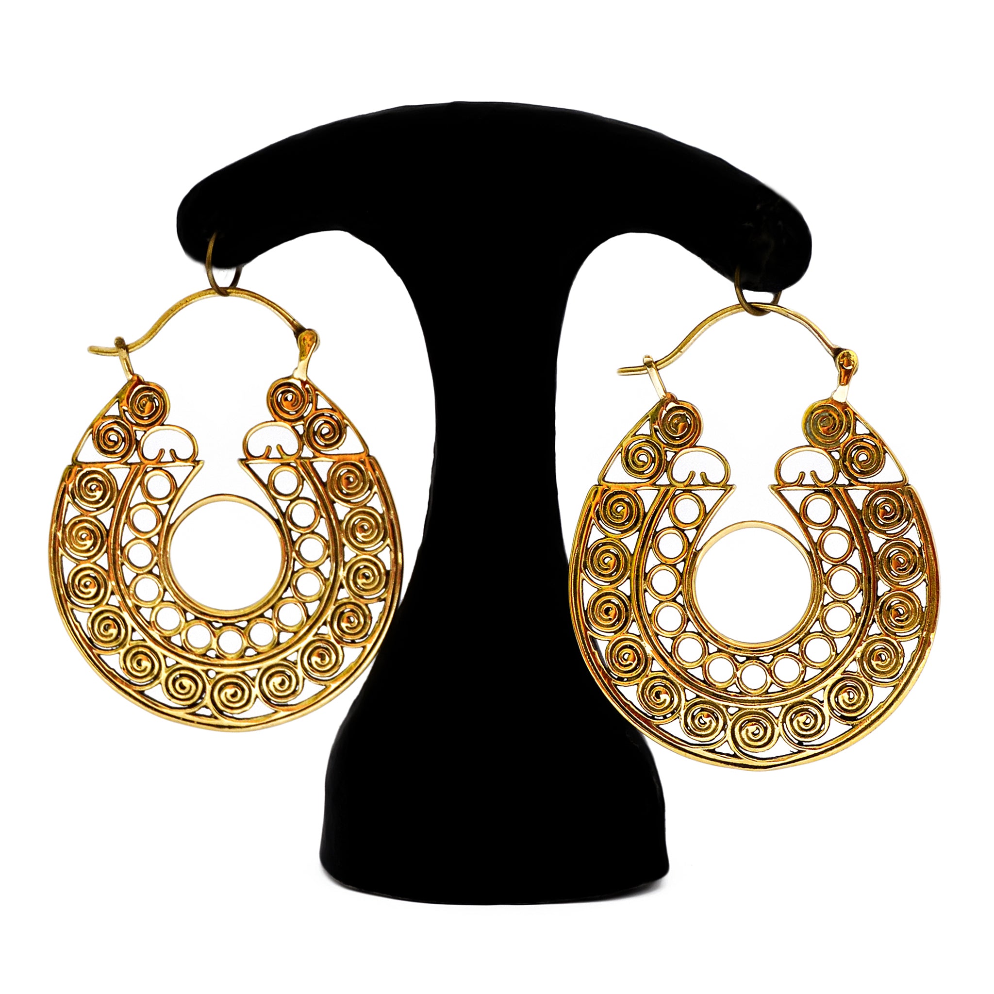 Gold tribal filigree hoop earrings hanging on a black stand