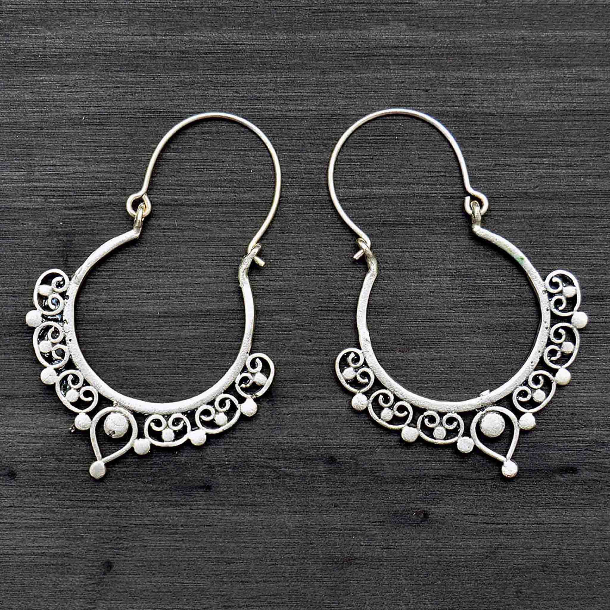 Silver tribal banjara hoop earrings on black background