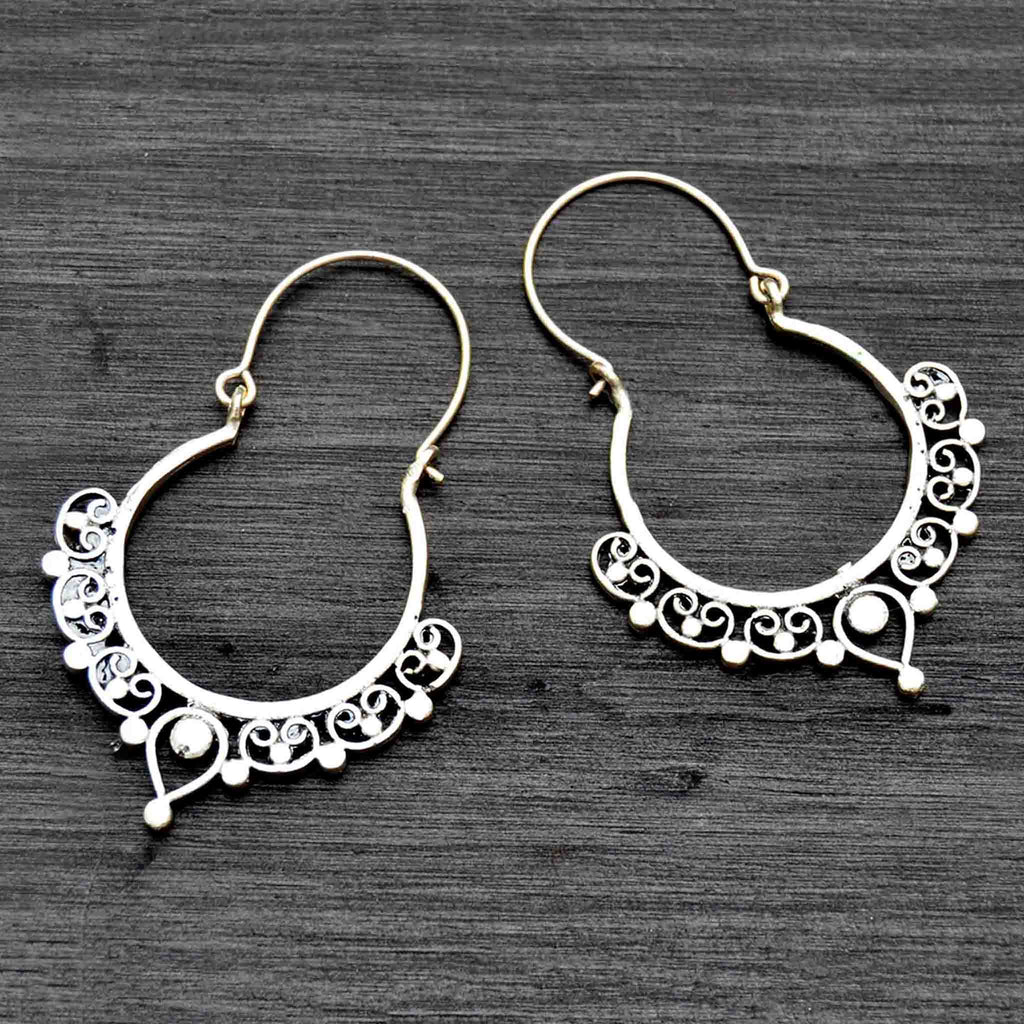Silver filigree indian hoop earrings on black background