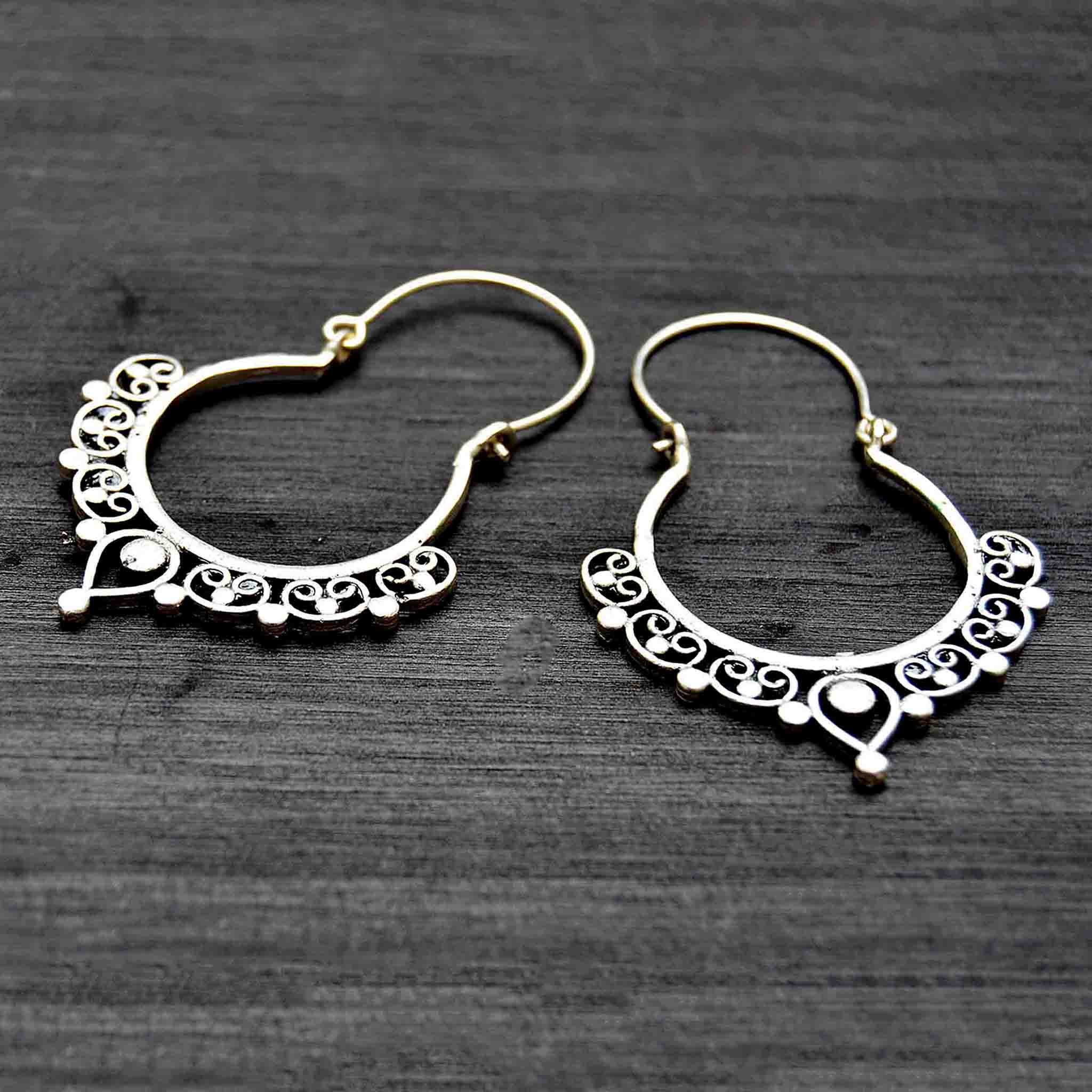 Silver ethnic banjara hoop earrings on black background