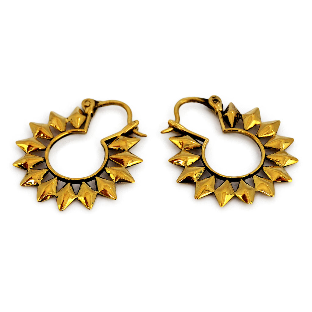 Small tribal gold sun hoop earrings on white background
