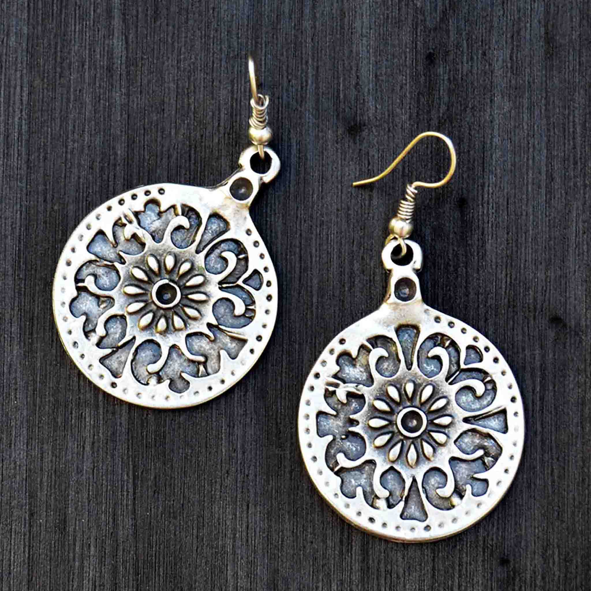 Silver celtic medallion  earrings on black background