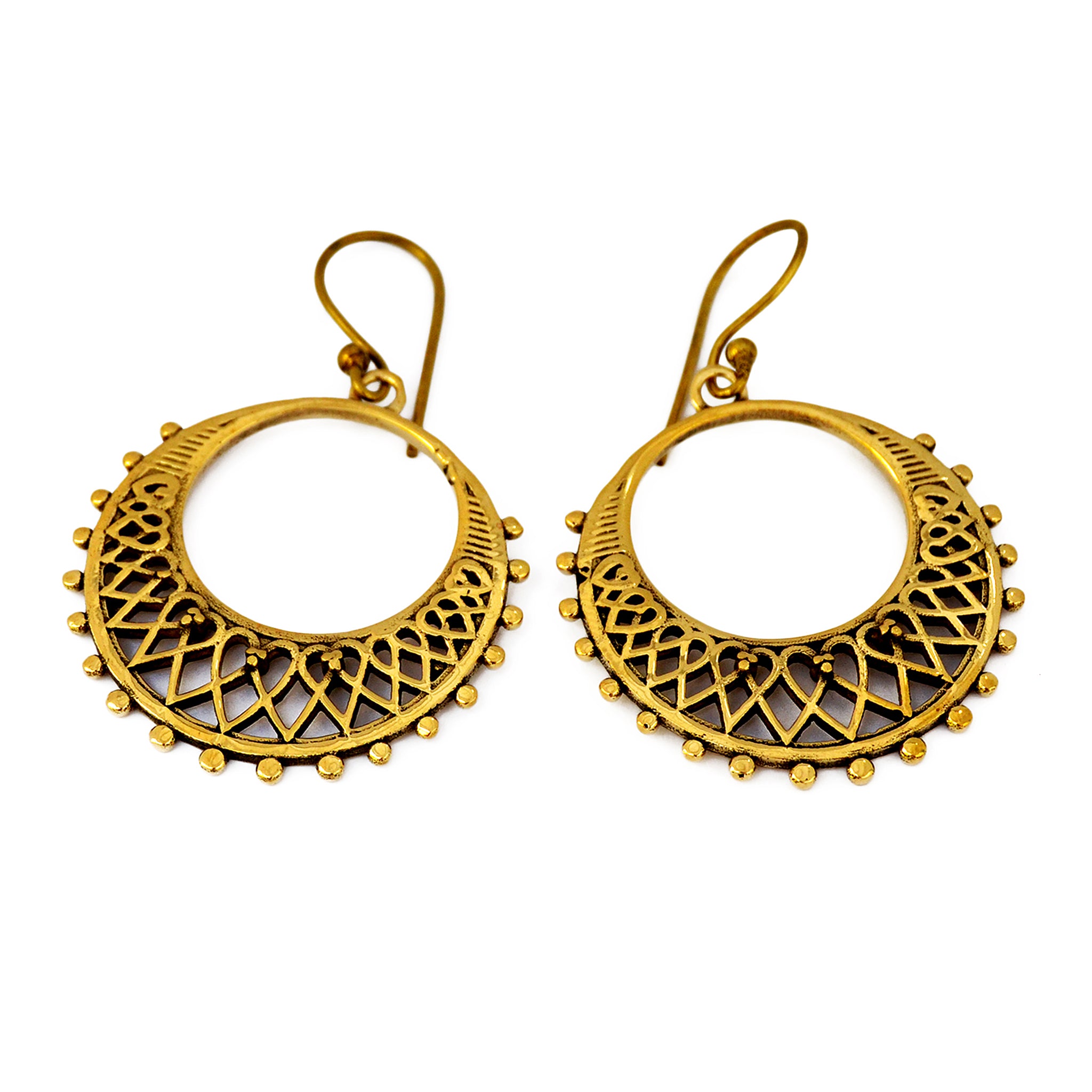 Golden hoop filigree earrings on white background