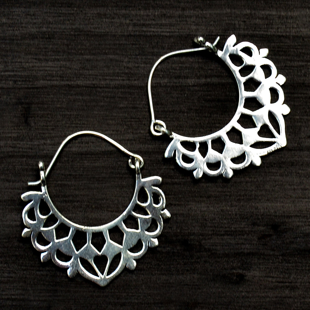 Ethnic silver balinese earrings on black background
