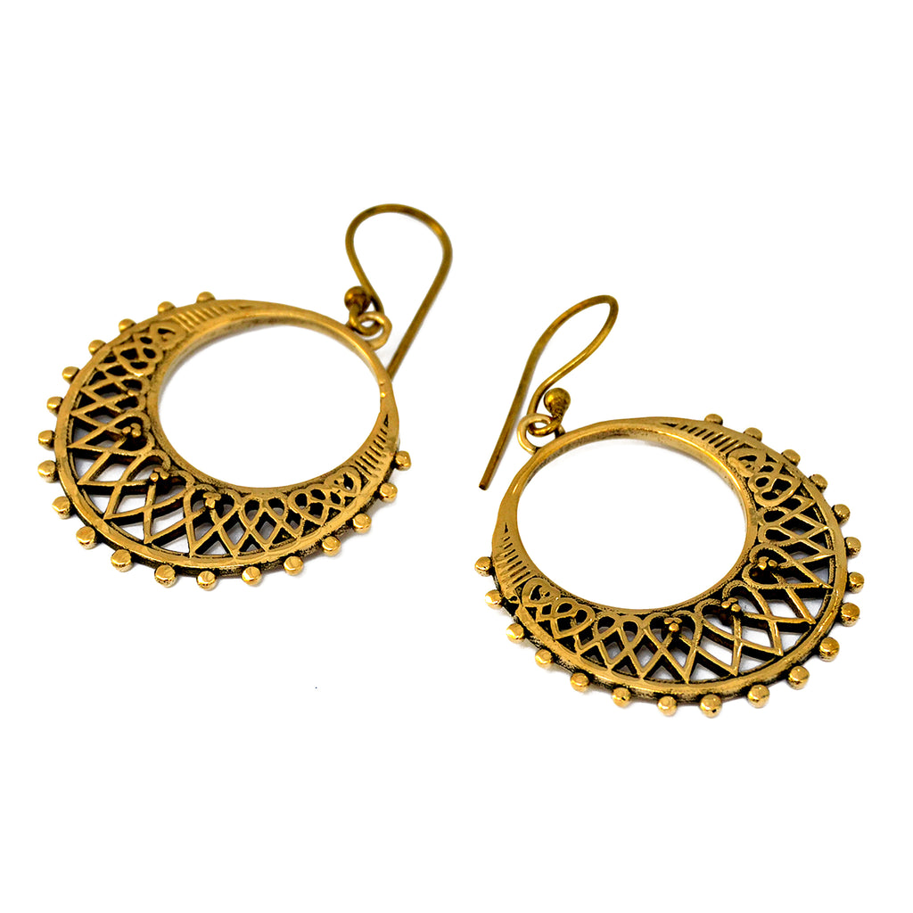 Gold hoop filigree earrings on white background