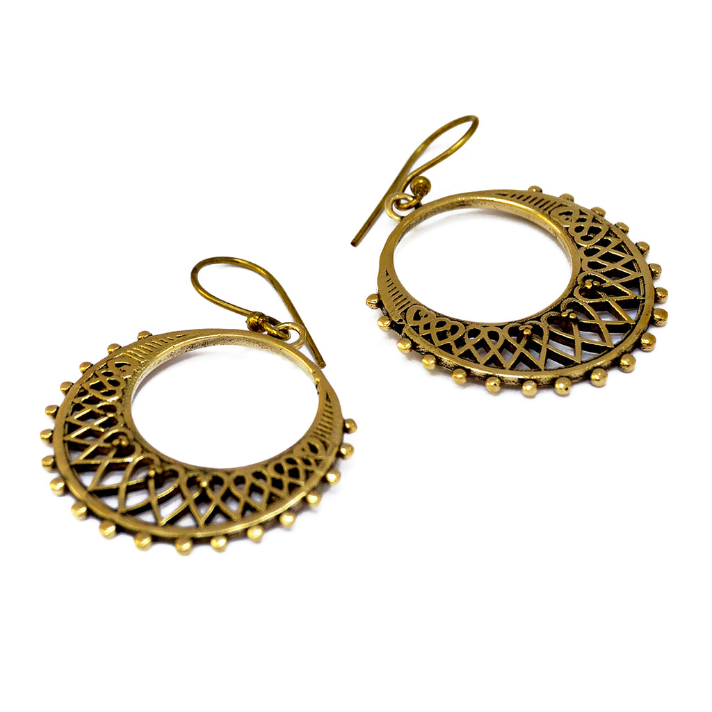 Brass indian hoop filigree earrings on white background