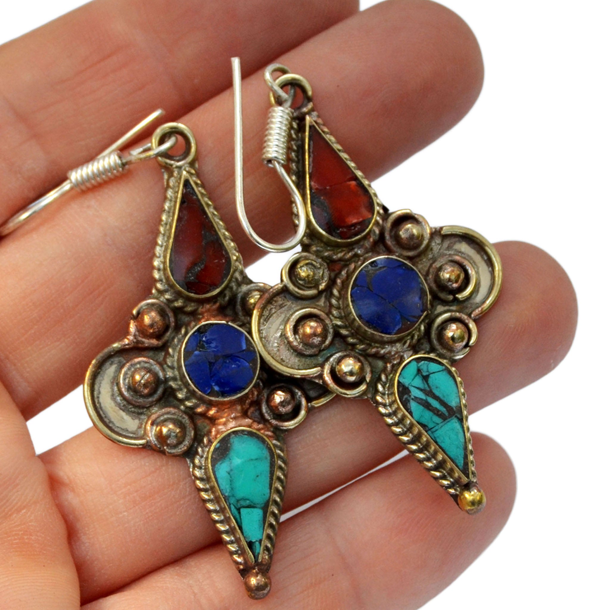 Silver tibetan earrings with inlay turquoise, lapis lazuli and red coral stones on hand