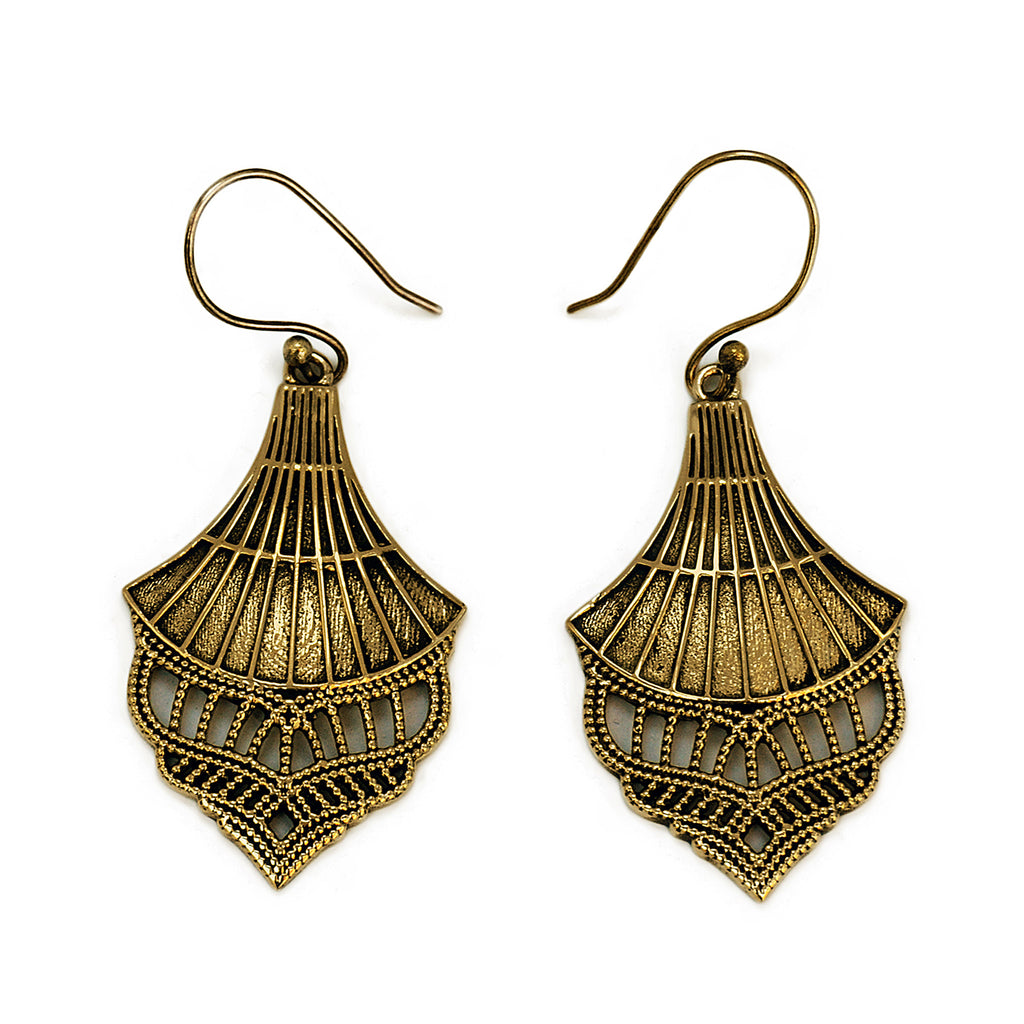 Gold vintage drop filigree earrings on white background