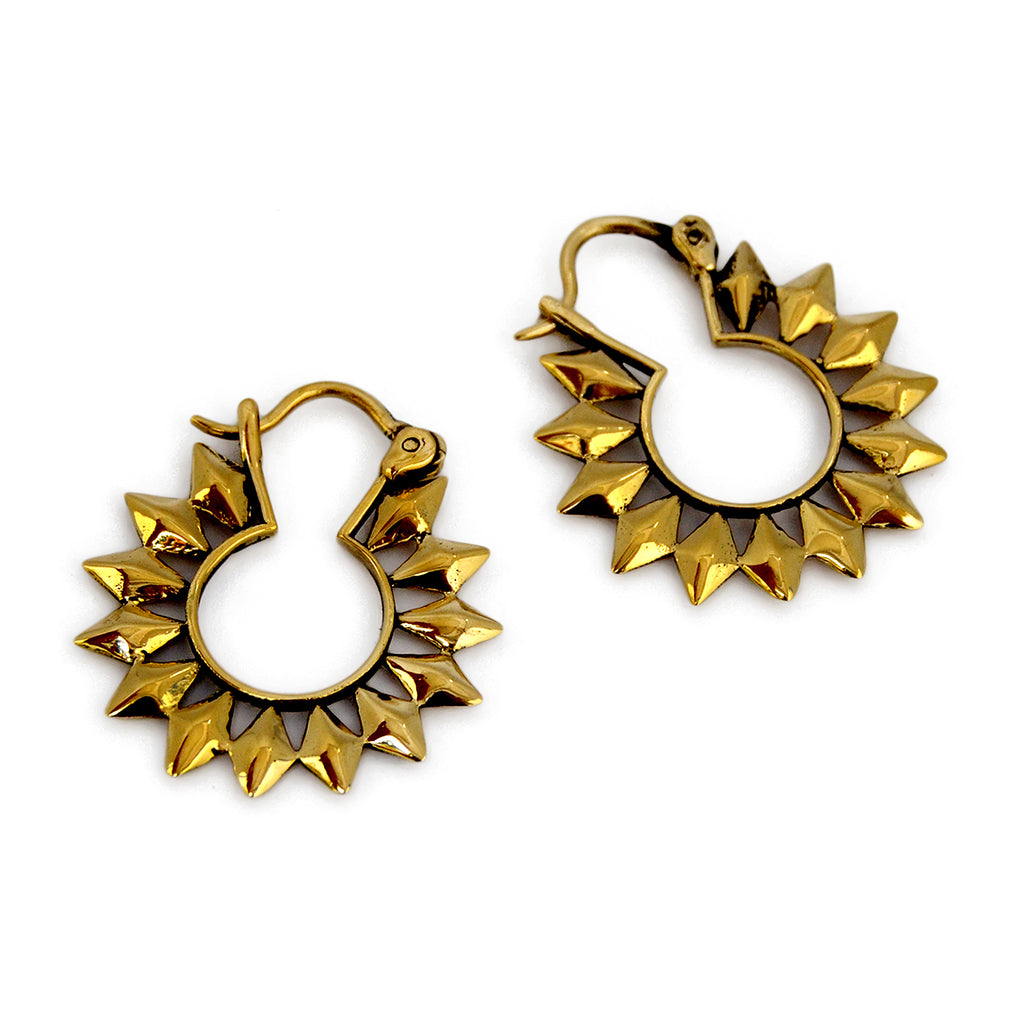 Small gold sun hoop earrings on white background