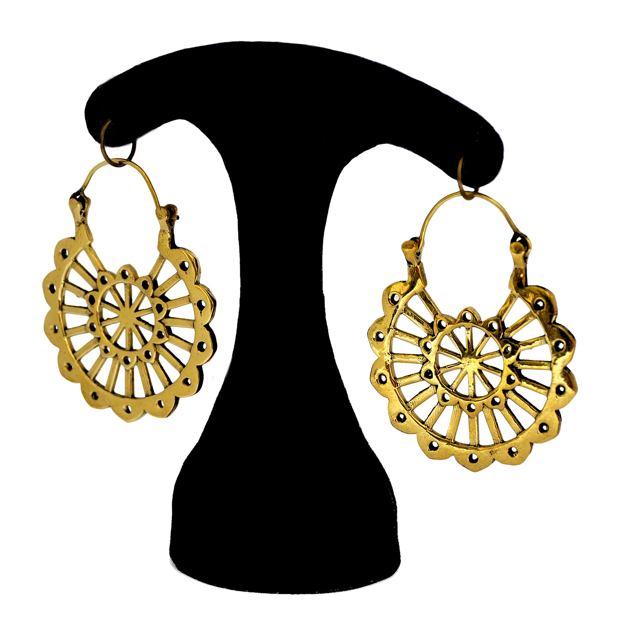 Brass mayan mandala earrings hanging on a black stand 