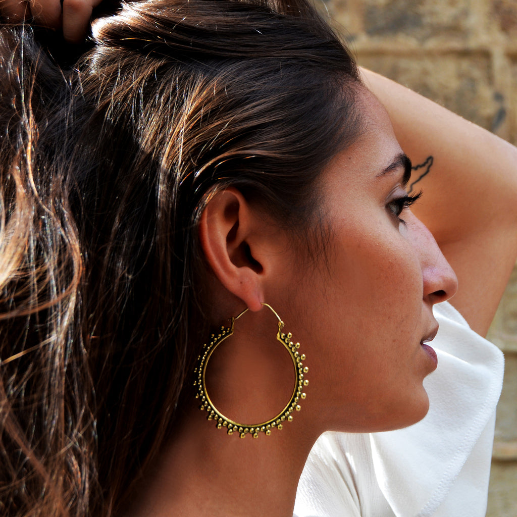 Woman with brass indian hoops