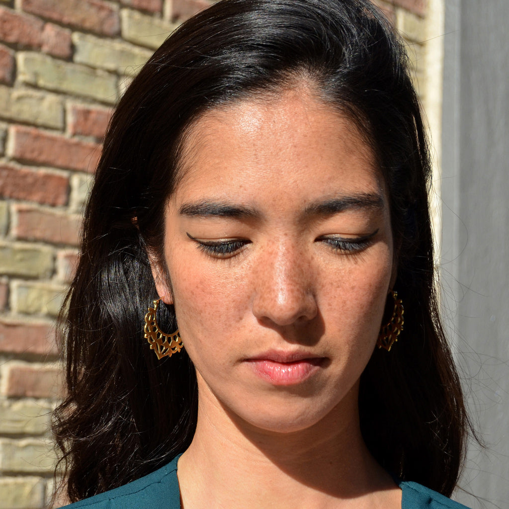 Young woman with balinese hoop earrings in gold