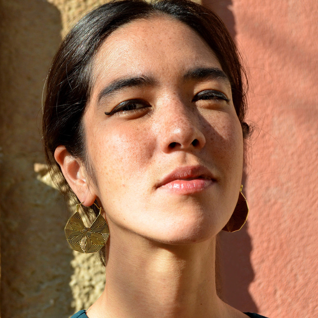 Young woman with tribal geometric mandala hoop earrings