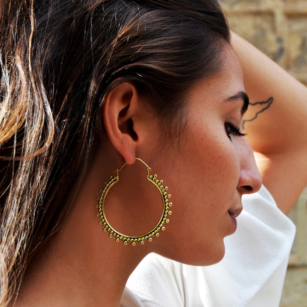 Woman with gypsy brass earrings