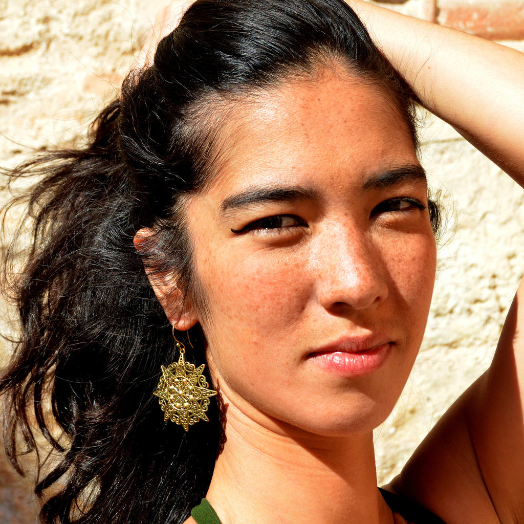 Woman with filigree mandala earrings